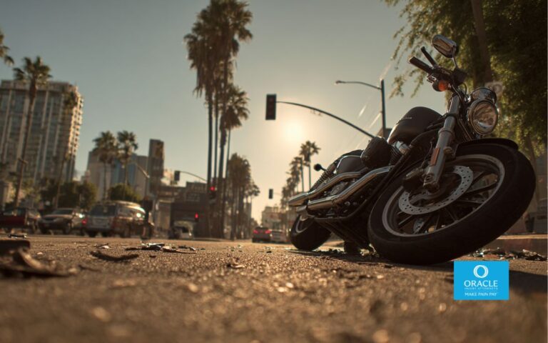 a motorcycle stopped after a collision on a Southern California city street, palm trees and low-rise buildings in the background, late afternoon natural light,