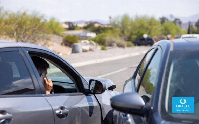 A realistic car accident scene in Hesperia, California, involving two vehicles on a suburban desert road, one driver looking stressed while speaking on the phone, natural lighting, high realism, no graphic injuries