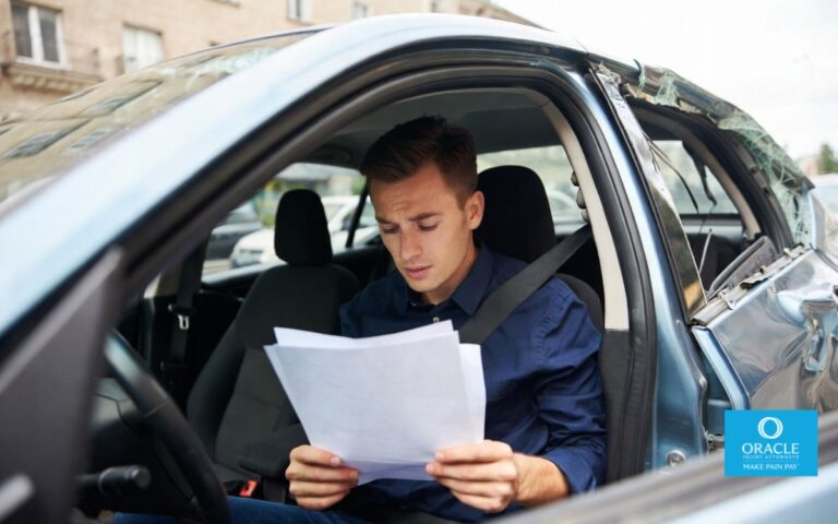 A stressed car accident victim sitting in a damaged vehicle holding paperwork and looking overwhelmed, urban street background, realistic lighting, emotional tension, high-detail, no text