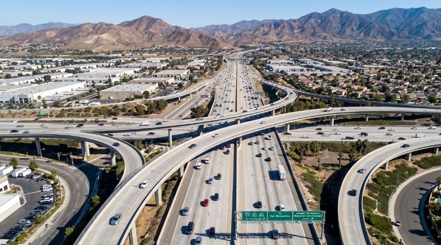 Car Accident Settlement Claims in Riverside: What Victims Should Know 3 An aerial or elevated view of a freeway interchange resembling the 215/91 corridor, moderate traffic, daylight, clean and professional. No collision depicted.