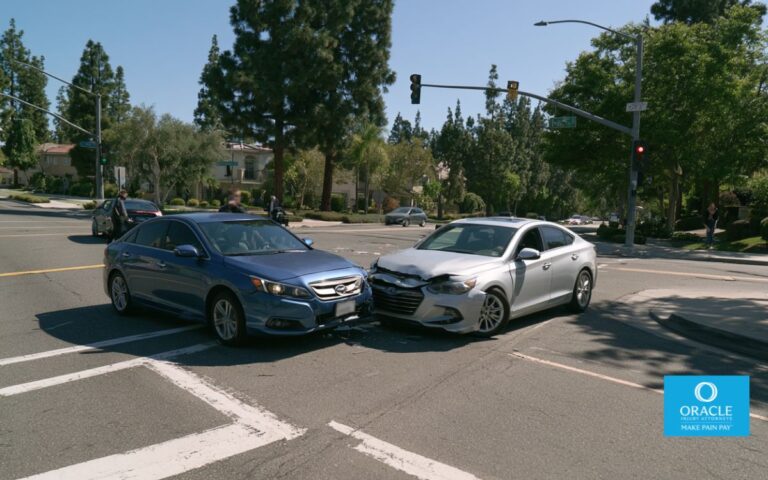 A wide shot of a two-car minor collision at a California suburban intersection, both vehicles with visible but minor damage, no people visible outside the cars, daylight. No graphic injuries. Represents the shared-fault scenario where both drivers contributed to the crash.