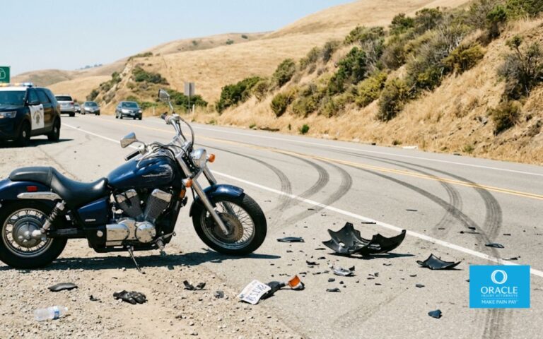 A motorcycle parked on the side of a California highway with visible road damage or debris nearby, daylight, no rider visible, no graphic injuries. Represents post-crash scene.