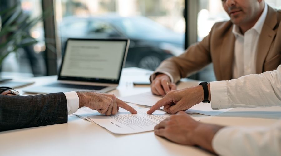 Attorney and client reviewing auto insurance coverage after a car accident