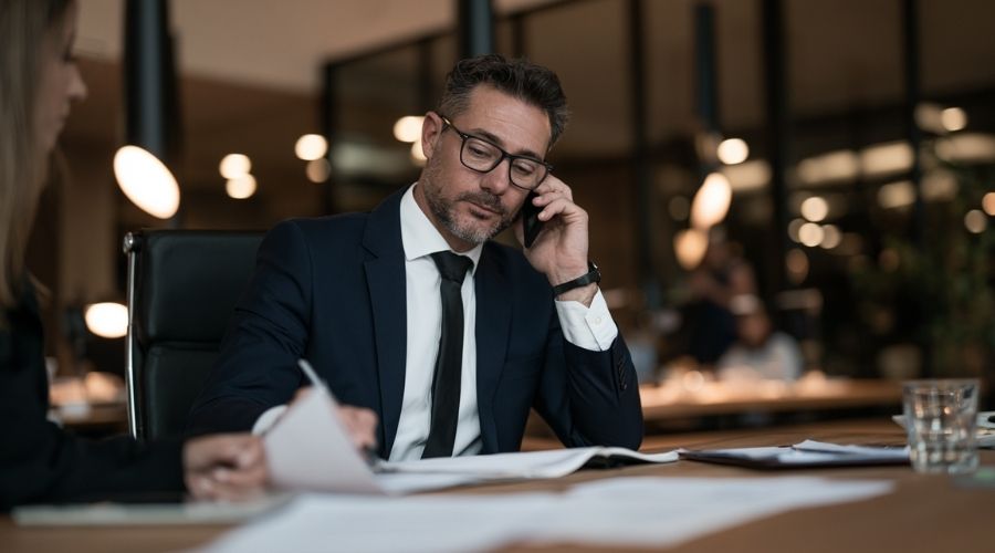 How to Talk to an Insurance Adjuster After an Accident 3 A calm attorney-client consultation: an attorney on the
phone at a desk with client documents in front of them,
representing the attorney taking over all adjuster
communication. No faces clearly identifiable, warm
office lighting.