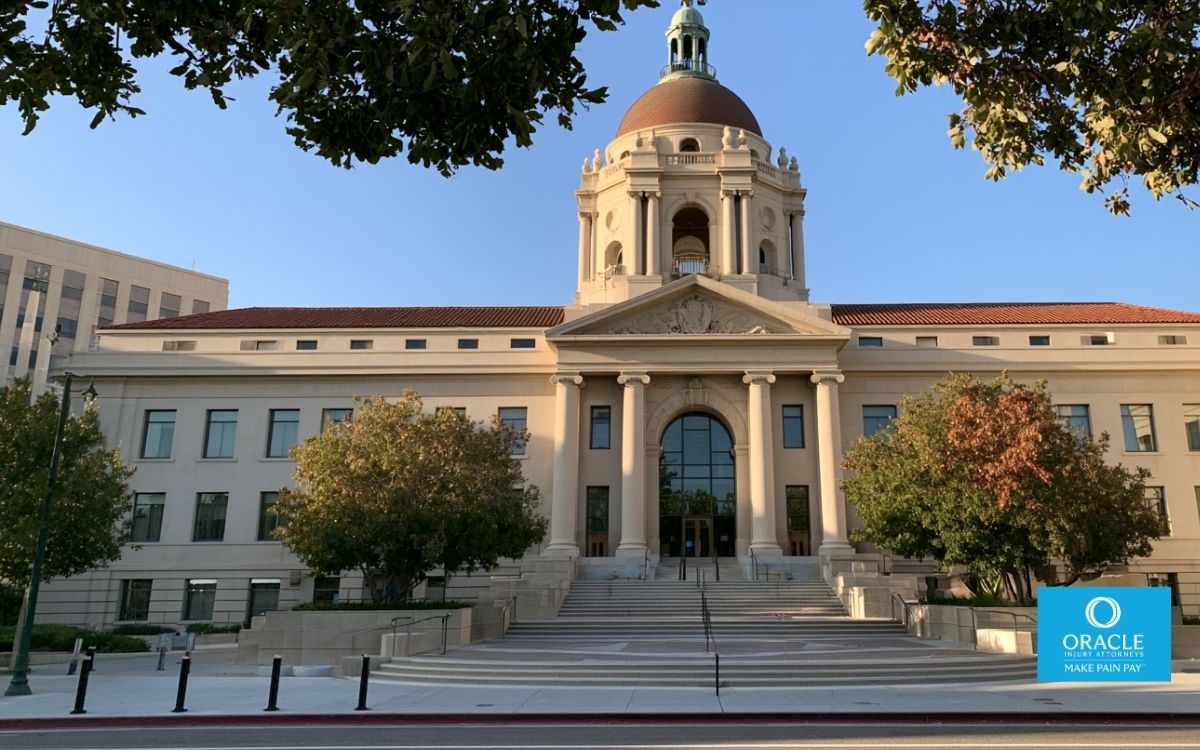 A wide exterior shot of the Pasadena Courthouse at 300 East Walnut Street, daylight, clear sky, trees visible in the foreground. Clean institutional tone, no faces. Represents the Pasadena Courthouse as the specific LA County Superior Court venue where Pasadena personal injury lawsuits are filed.