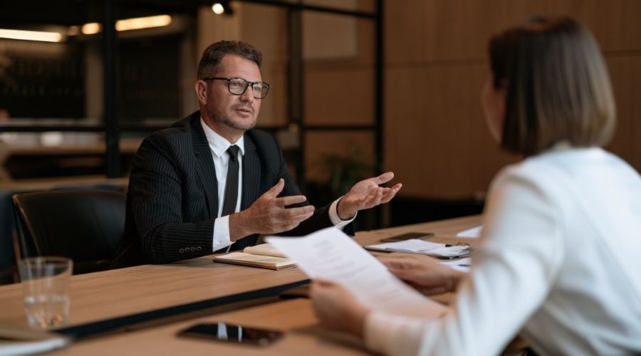 Do I Really Need a Personal Injury Lawyer in Orange County? 3 A calm, professional attorney-client consultation: two
people at a conference table in a warm Orange County
office, one reviewing case documents, the other listening.
No faces clearly identifiable. Represents the free
consultation that answers the "do I need a lawyer"
question with specificity rather than guesswork.