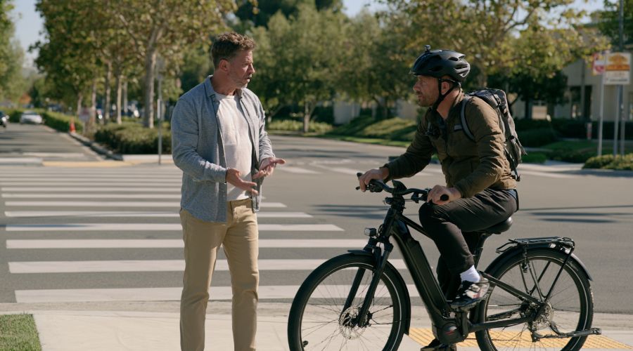 E-Bike Accident in Orange County? Know Your Rights 2 Pedestrian and e-bike rider speaking near a school crosswalk in Irvine, California.